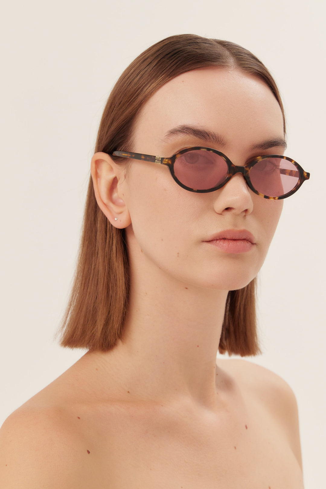 Occhiali da sole ovali Miu Miu in acetato marrone e rosa